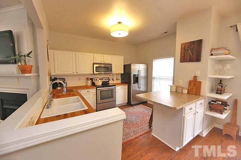5121 Echo Ridge Road Raleigh, NC 27612 - Photo 3 of 16 a kitchen with stainless steel appliances granite countertop a sink stove and refrigerator