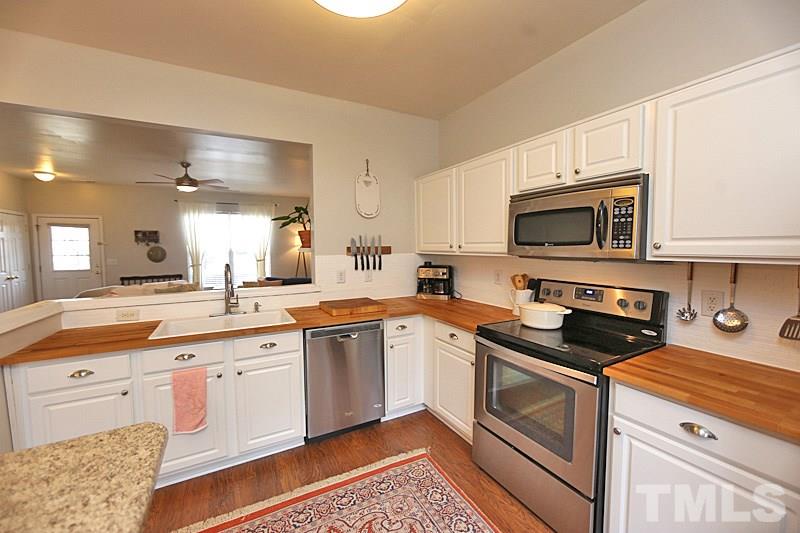 5121 Echo Ridge Road Raleigh, NC 27612 - Photo 4 of 16 a kitchen with a sink stove and microwave