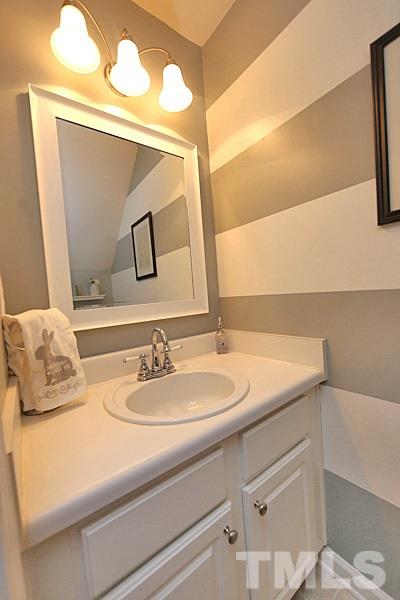 5121 Echo Ridge Road Raleigh, NC 27612 - Photo 6 of 16 a bathroom with a sink and a mirror