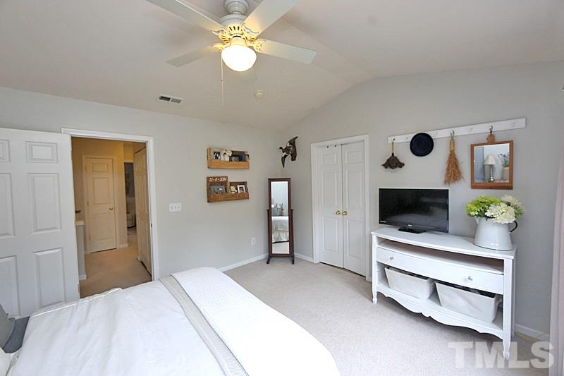 5121 Echo Ridge Road Raleigh, NC 27612 - Photo 8 of 16 a bedroom with a bed and a flat screen tv