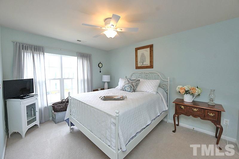 5121 Echo Ridge Road Raleigh, NC 27612 - Photo 10 of 16 a bedroom with a bed and a flat screen tv