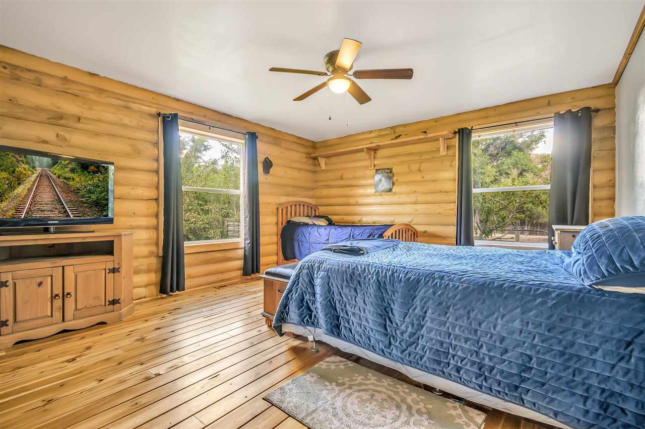 3301 F Road Clifton, CO 81520 - Photo 11 of 42 a bed sitting in a bedroom next to a window
