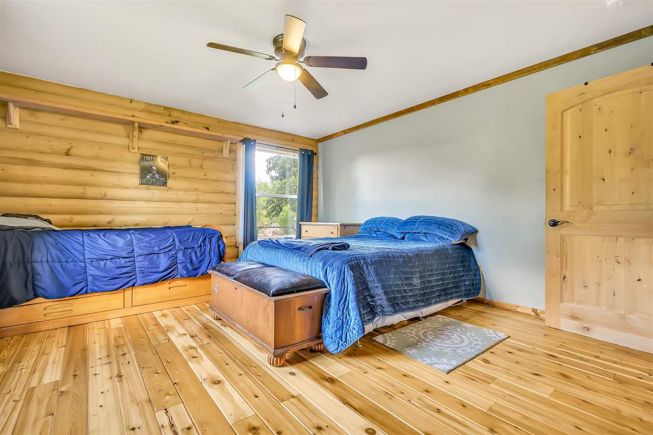 3301 F Road Clifton, CO 81520 - Photo 13 of 42 a bedroom with a bed and ceiling fan