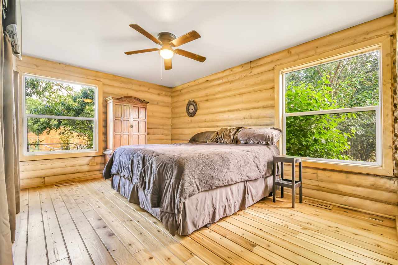 3301 F Road Clifton, CO 81520 - Photo 15 of 42 a bedroom with a large bed and a large window