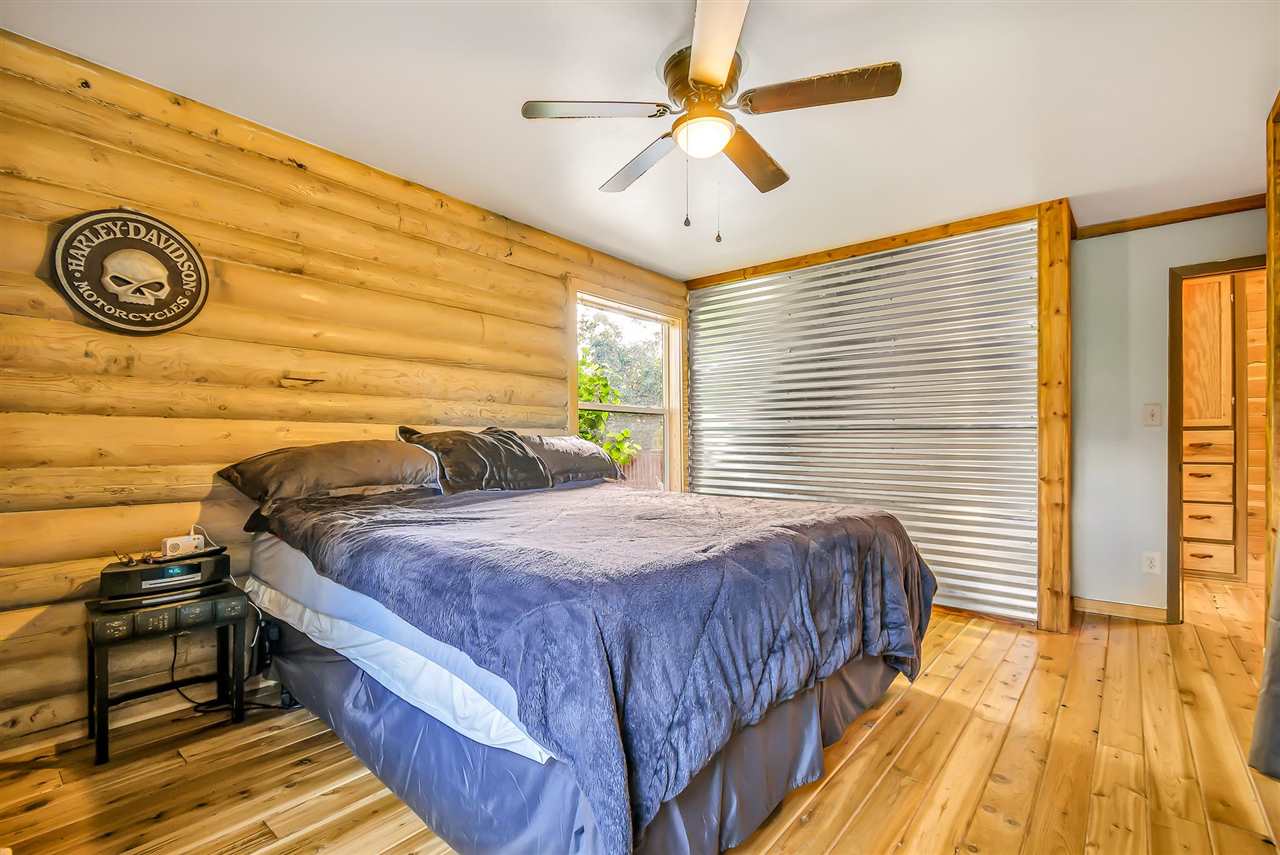 3301 F Road Clifton, CO 81520 - Photo 16 of 42 a bedroom with a bed and a chandelier
