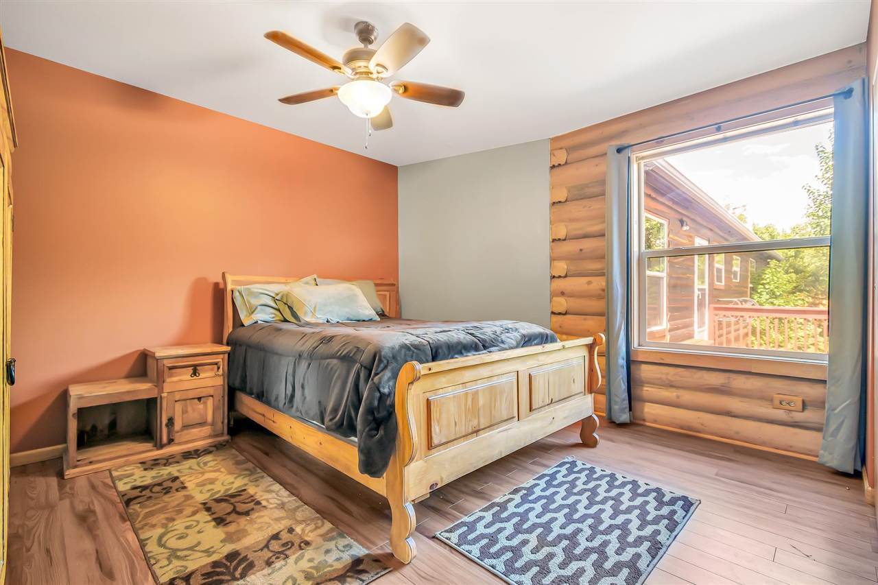 3301 F Road Clifton, CO 81520 - Photo 23 of 42 a bedroom with a bed rug and wooden floor