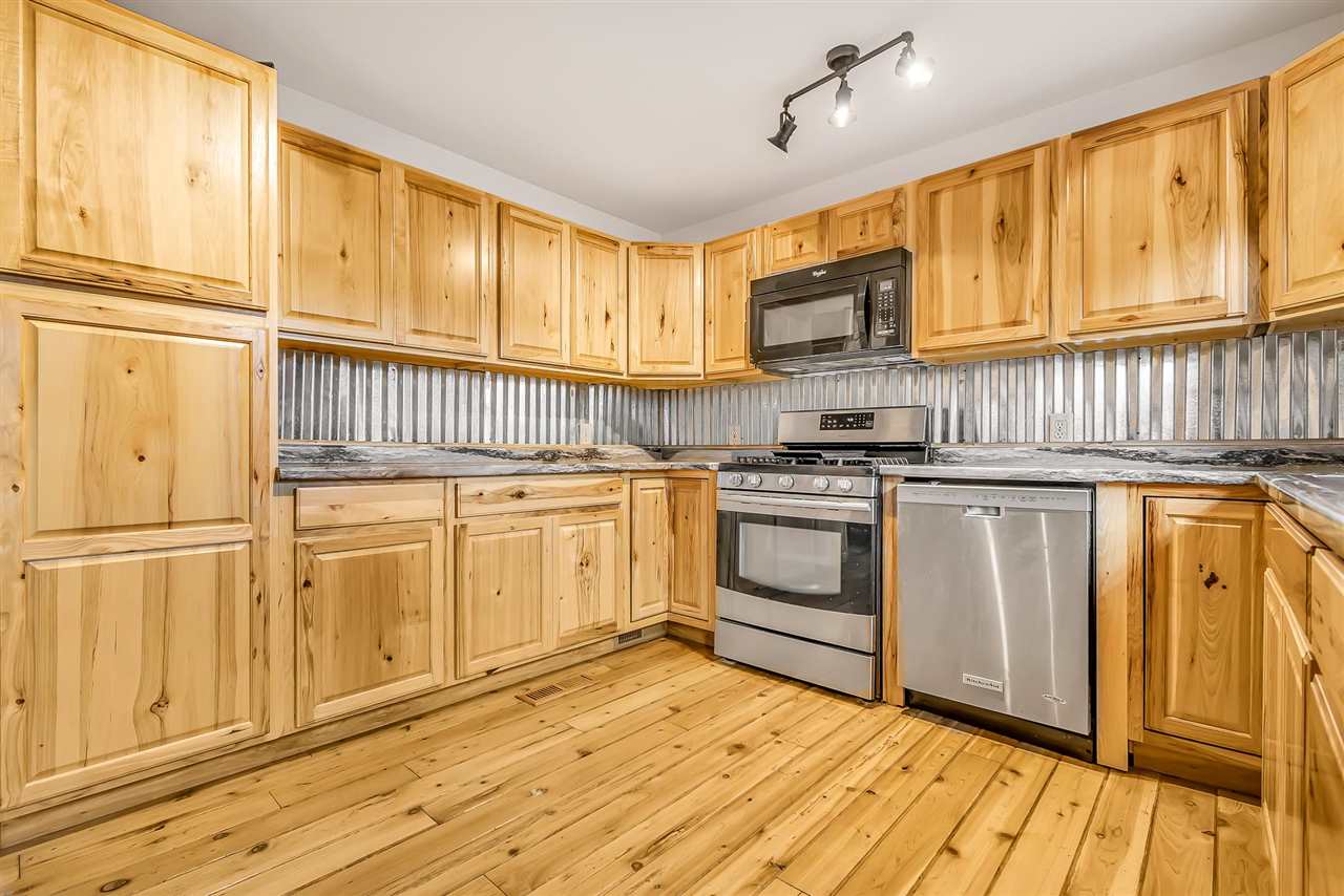 3301 F Road Clifton, CO 81520 - Photo 9 of 42 a kitchen with granite countertop white cabinets and white appliances