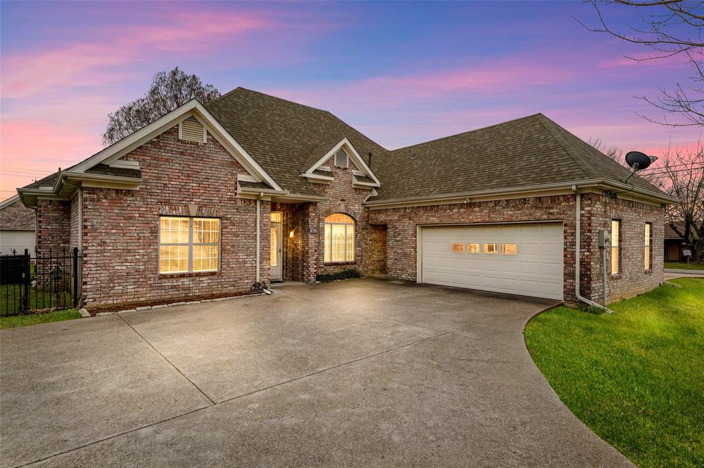 a view of a house with a yard and garage