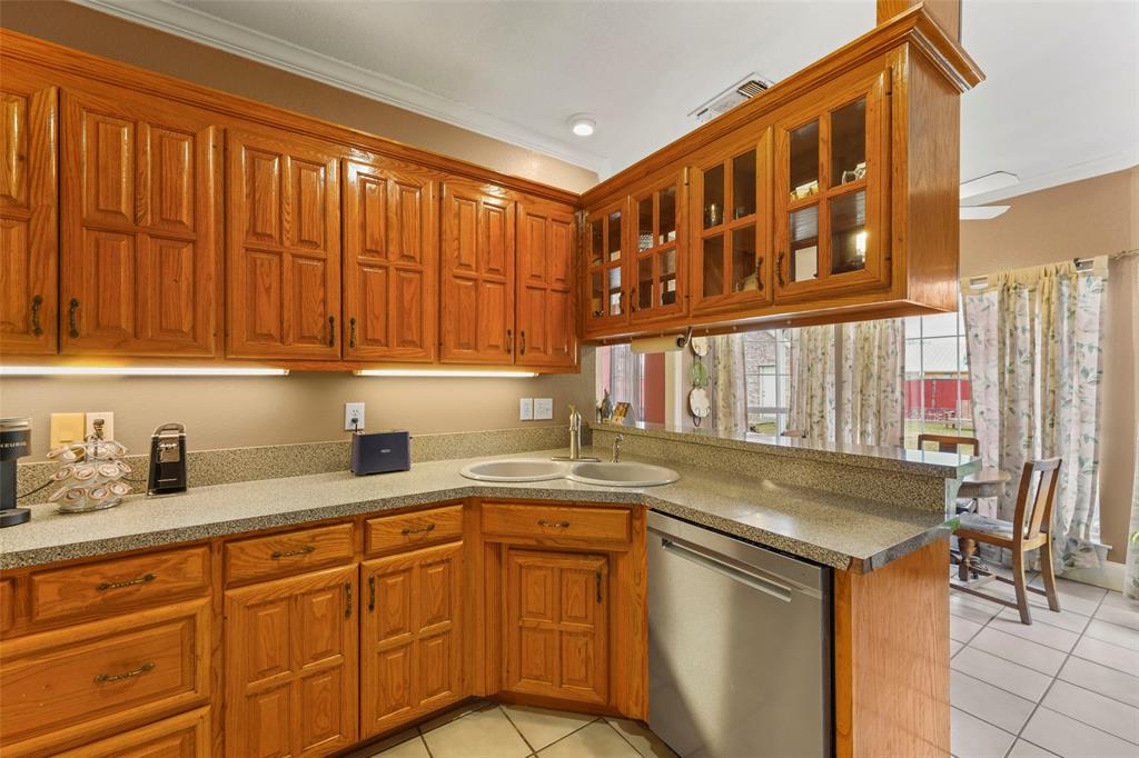 301 Elm Street Quinlan, TX 75474 - Photo 12 of 40 a kitchen with stainless steel appliances granite countertop a sink and cabinets