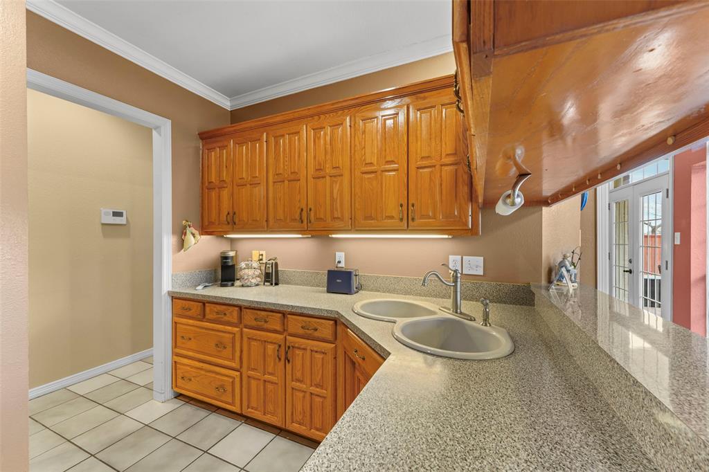 301 Elm Street Quinlan, TX 75474 - Photo 15 of 40 a spacious bathroom with a granite countertop sink and a mirror