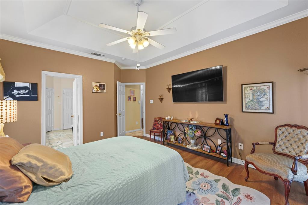 301 Elm Street Quinlan, TX 75474 - Photo 19 of 40 a bedroom with furniture and a flat screen tv