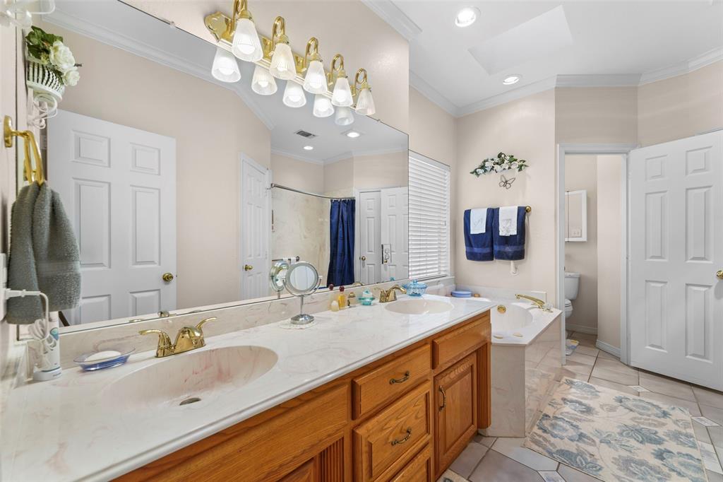 301 Elm Street Quinlan, TX 75474 - Photo 20 of 40 a spacious bathroom with a double vanity sink mirror and double