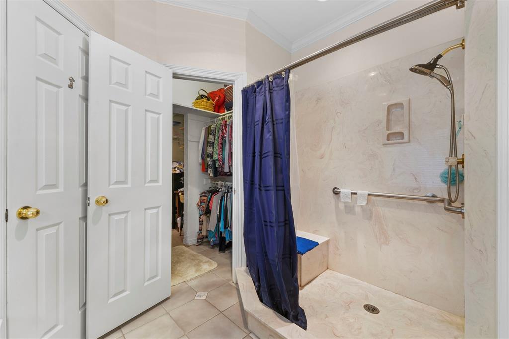 301 Elm Street Quinlan, TX 75474 - Photo 21 of 40 a bathroom with a shower and a glass door