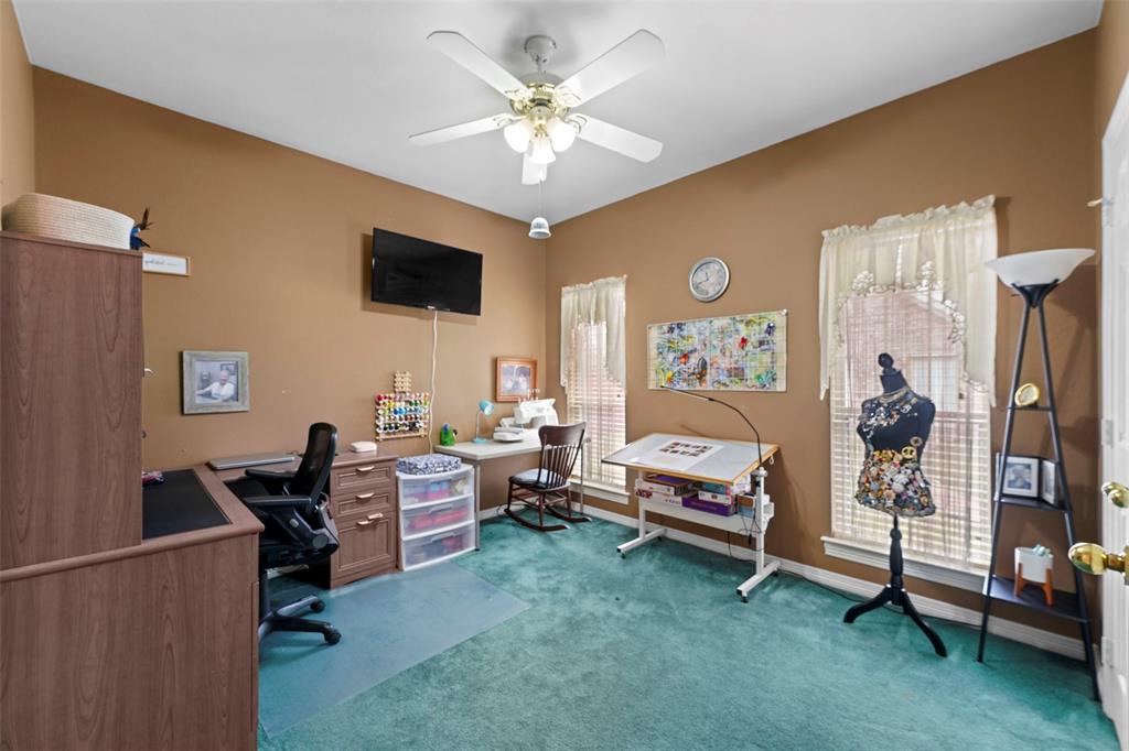 301 Elm Street Quinlan, TX 75474 - Photo 23 of 40 a living room with furniture and a flat screen tv