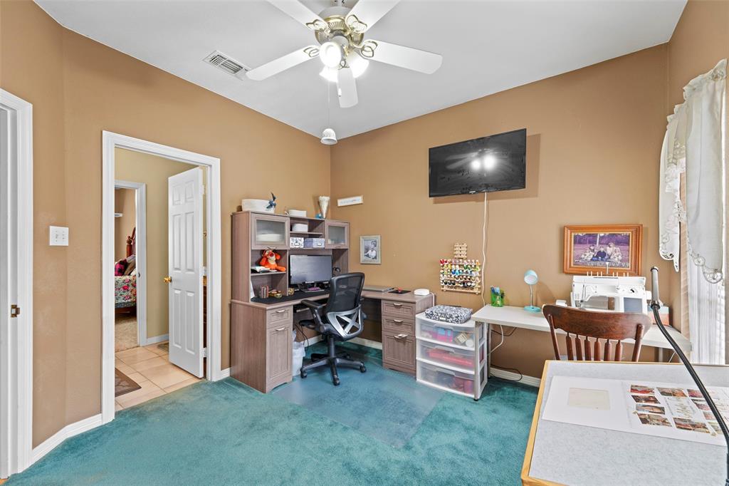 301 Elm Street Quinlan, TX 75474 - Photo 24 of 40 a living room with furniture and a flat screen tv