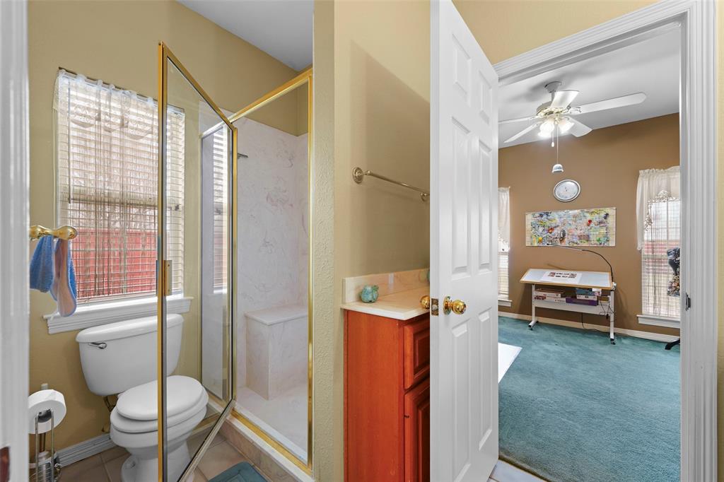 301 Elm Street Quinlan, TX 75474 - Photo 28 of 40 a bathroom with a sink toilet and shower