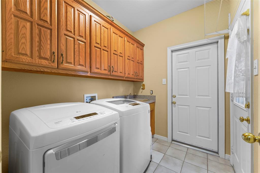 301 Elm Street Quinlan, TX 75474 - Photo 29 of 40 a utility room with dryer and washer