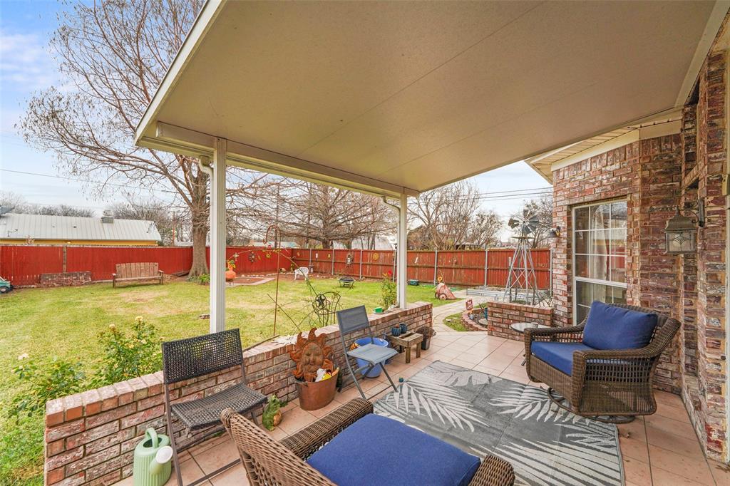 301 Elm Street Quinlan, TX 75474 - Photo 31 of 40 a building outdoor space with patio furniture and a garden