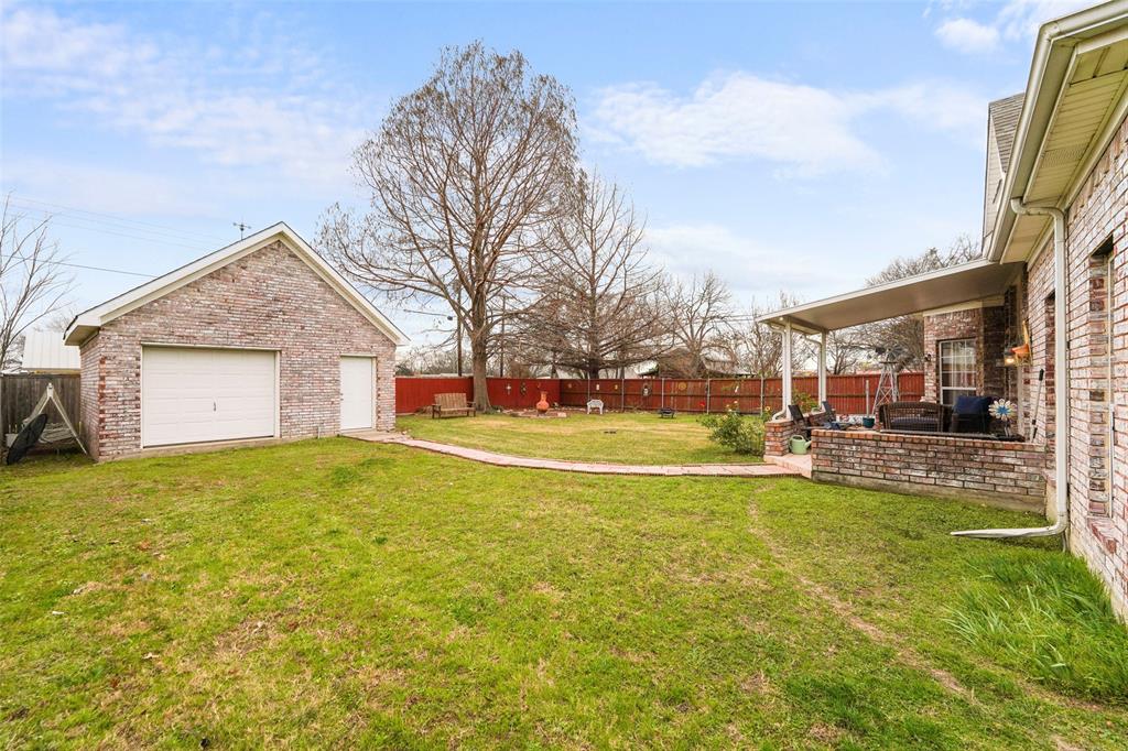 301 Elm Street Quinlan, TX 75474 - Photo 32 of 40 a swimming pool with outdoor seating and yard