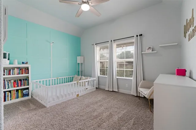 a room with a book shelf and a window