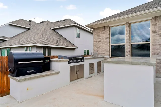 a kitchen that has a stove and white cabinets