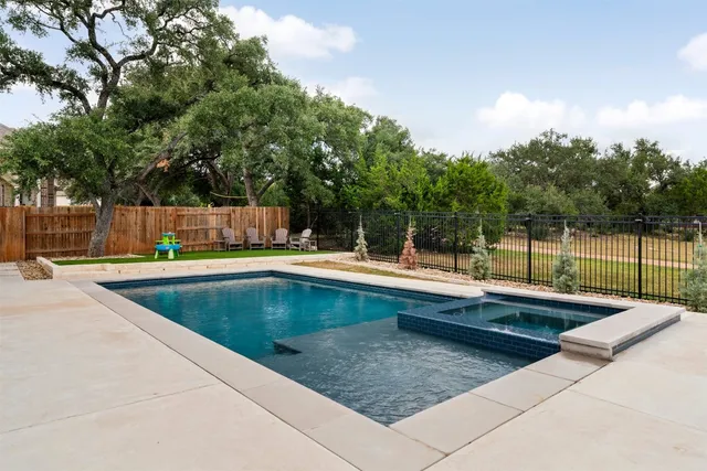 a view of a swimming pool with a patio