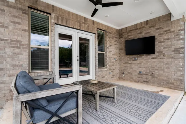 a outdoor living space with a couch and a flat screen tv