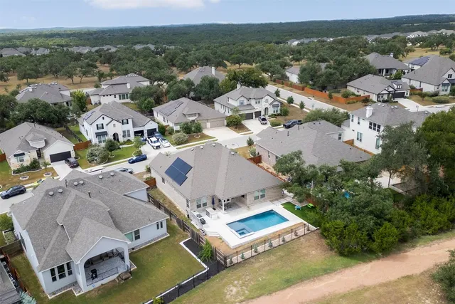 an aerial view of residential houses with outdoor space