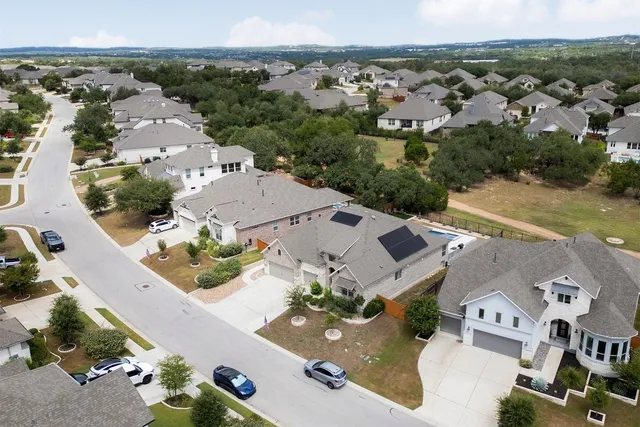 an aerial view of multiple houses with yard