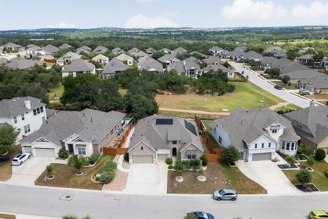 an aerial view of residential houses with outdoor space