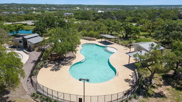 an aerial view of a house with swimming pool and garden view