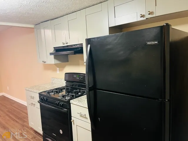 a kitchen with a stove and a refrigerator