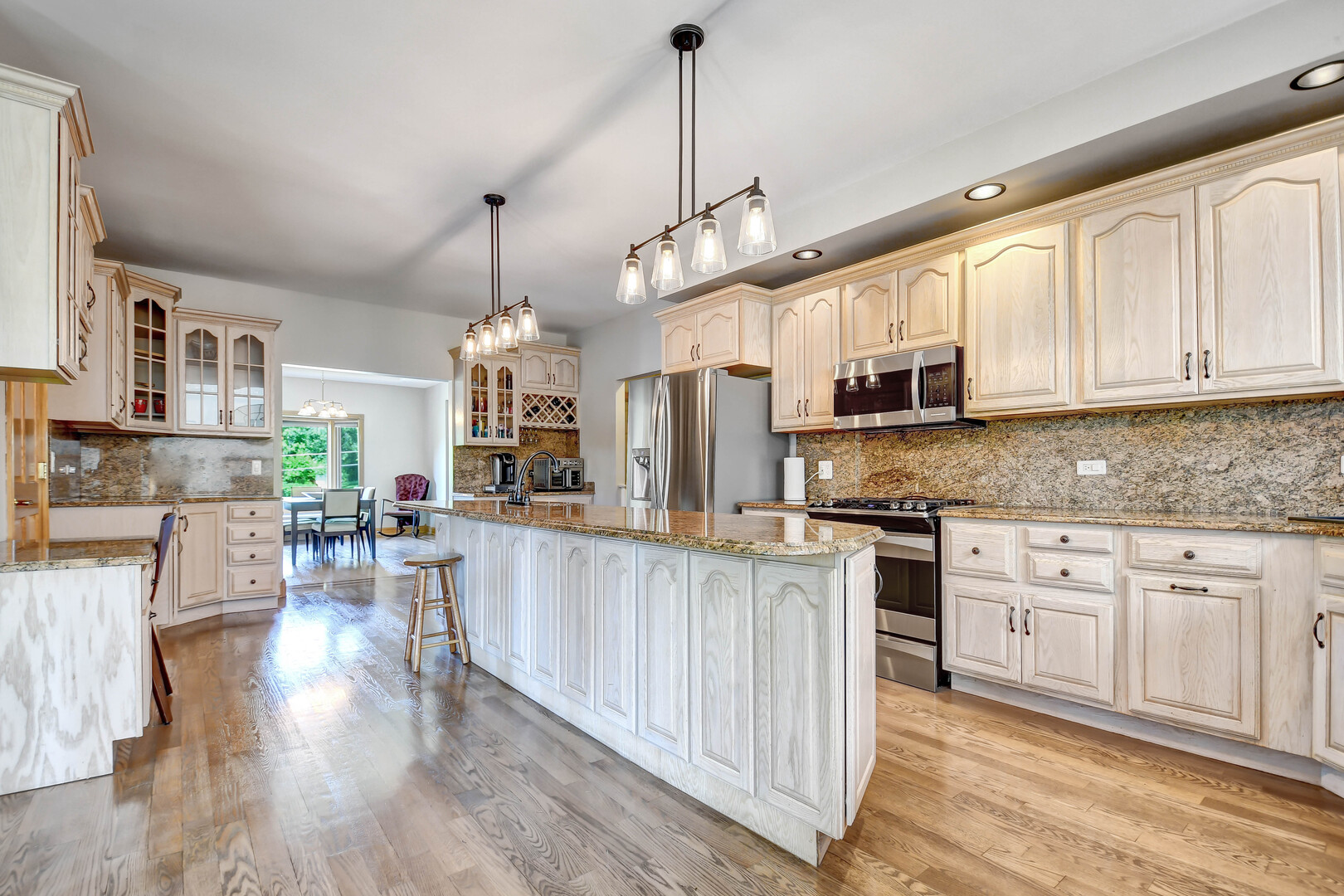 1383 Gordon Lane Lemont, IL 60439 - Photo 11 of 54 a kitchen with stainless steel appliances granite countertop a refrigerator a stove top oven a sink dishwasher and white cabinets with wooden floor