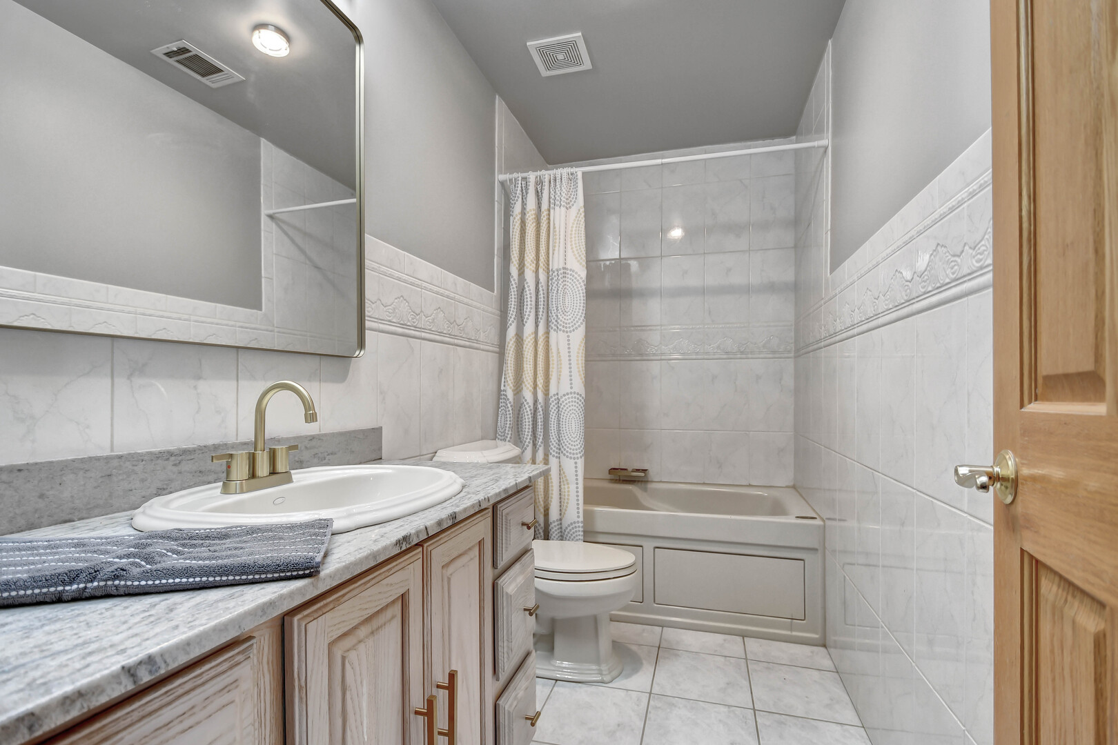 1383 Gordon Lane Lemont, IL 60439 - Photo 30 of 54 a bathroom with a granite countertop sink a toilet and shower