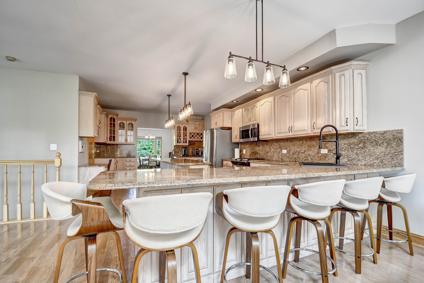 1383 Gordon Lane Lemont, IL 60439 - Photo 10 of 54 a kitchen with stainless steel appliances granite countertop a dining table chairs and sink