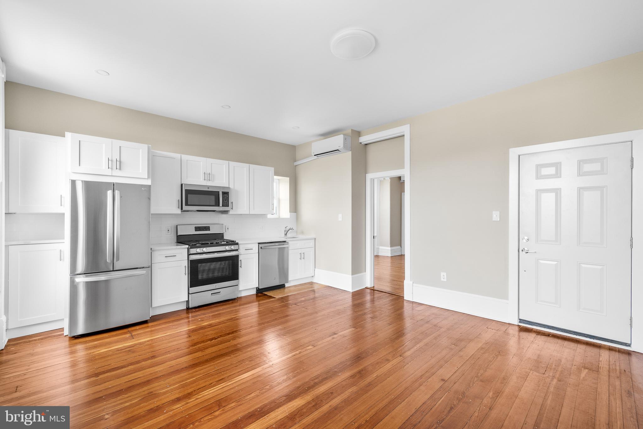 2311 Green Street, Unit 2F Philadelphia, PA 19130 - Photo 3 of 13 a kitchen with granite countertop a refrigerator and a stove top oven