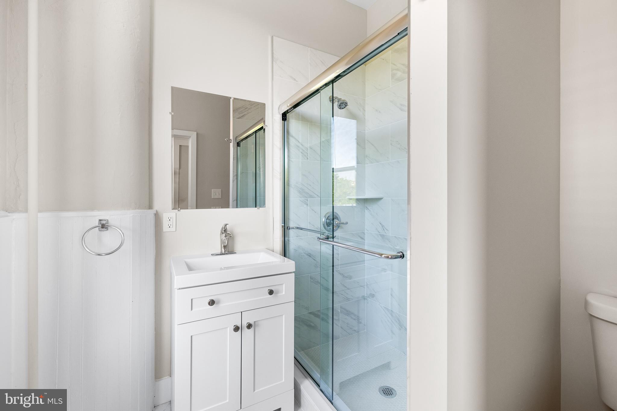 2311 Green Street, Unit 2F Philadelphia, PA 19130 - Photo 10 of 13 a bathroom with a shower sink and mirror