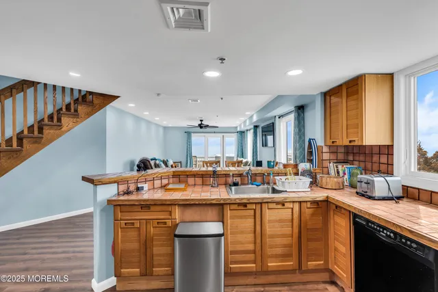 a kitchen with a sink cabinets and stainless steel appliances