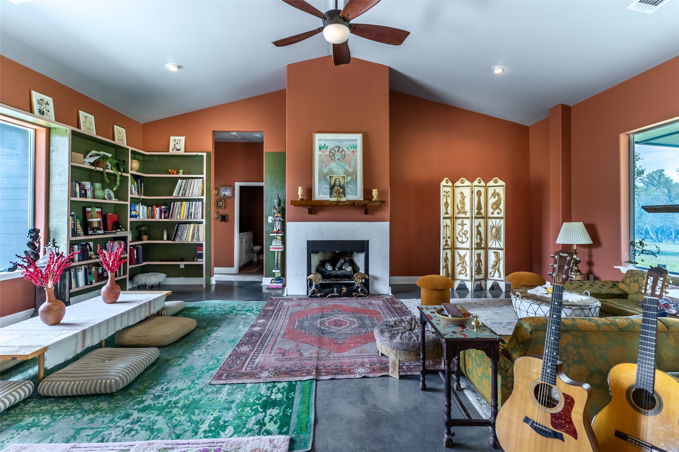 4082 Old Colony Line Road Lockhart, TX 78644 - Photo 8 of 40 A terracotta-hued living area features an impressive fireplace and extensive built-in shelving.