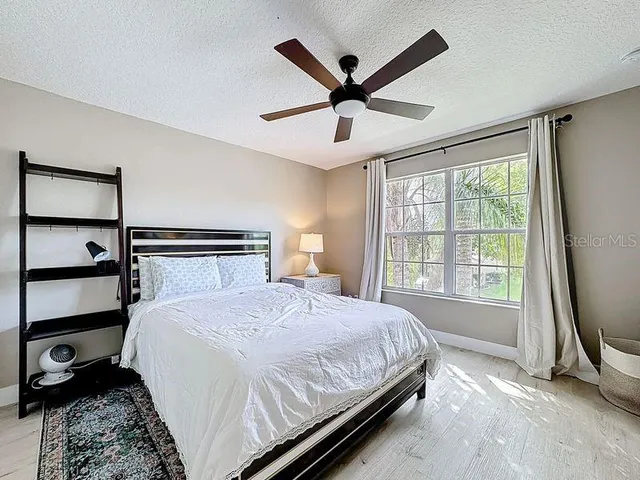 a spacious bedroom with a bed and a table in it