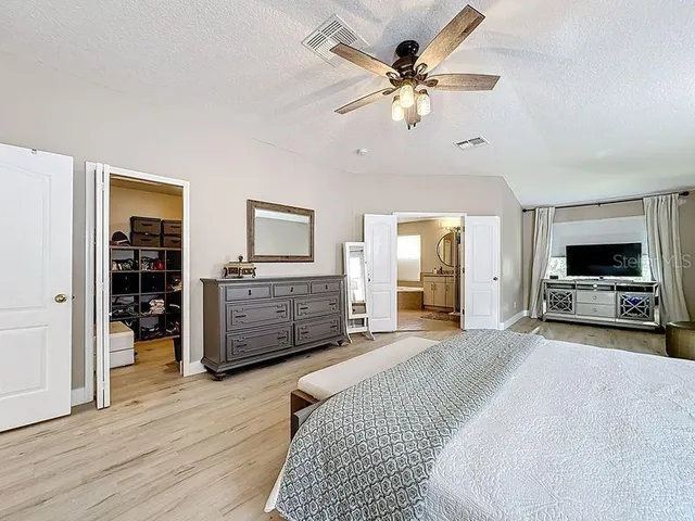a bathroom with a granite countertop sink a mirror and a bathtub