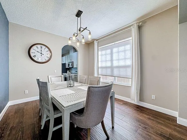 a view of a dining room with furniture wooden floor and a chandelier