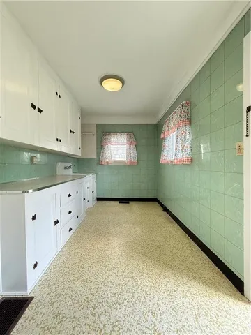 a utility room with stainless steel appliances washer and dryer