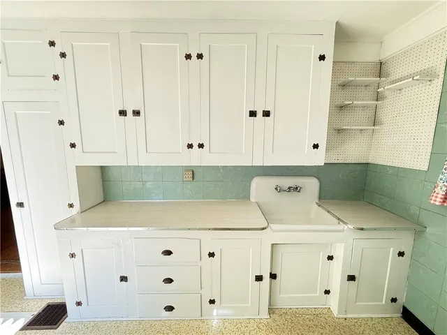 an empty room with wooden floor fireplace and windows