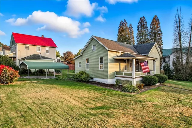 a view of house with outdoor space and swimming pool