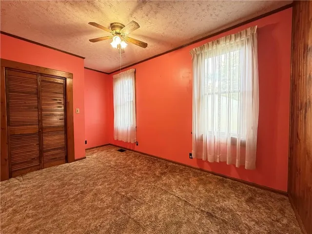a view of a room with wooden floor and windows