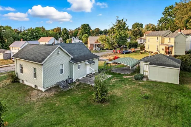 a view of backyard of house with green space
