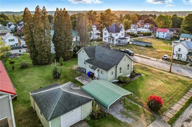 a view of a house with a yard and pathway