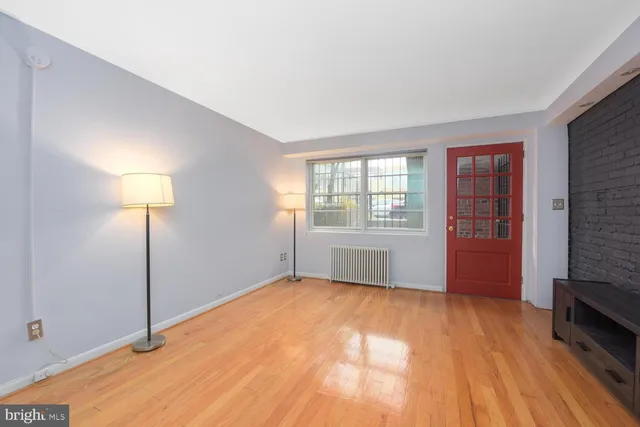 a view of an empty room with a fireplace and a window