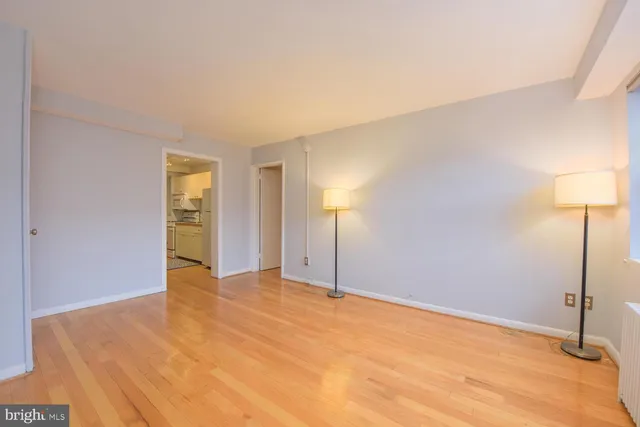 a view of a livingroom with wooden floor and a fireplace